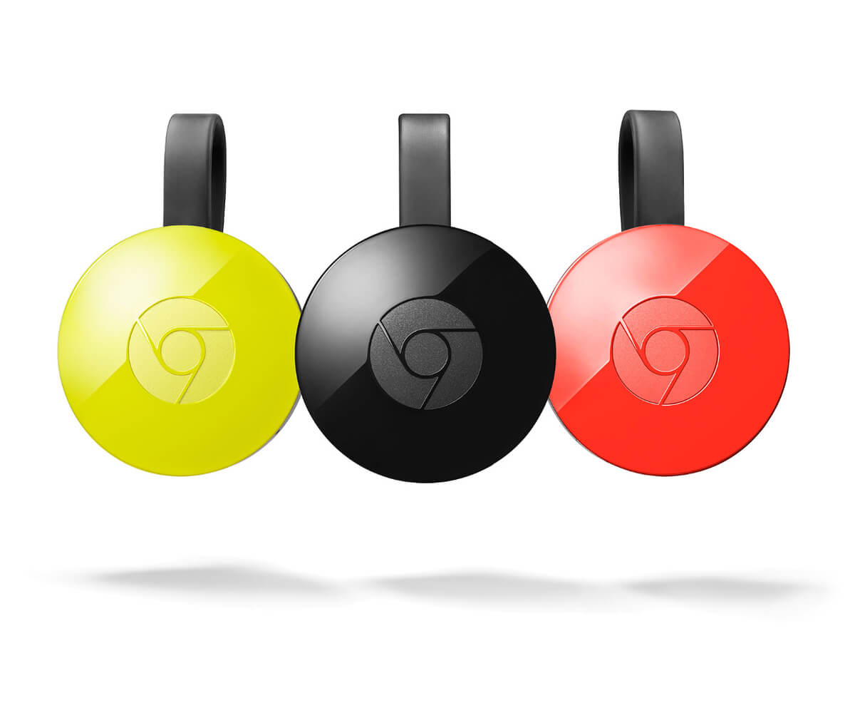 Three Google Chromecasts side by side, coloured yellow, black and red.